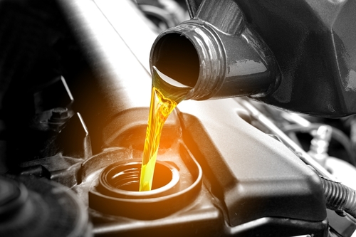 Refueling,and,pouring,oil,quality,into,the,engine,motor,car